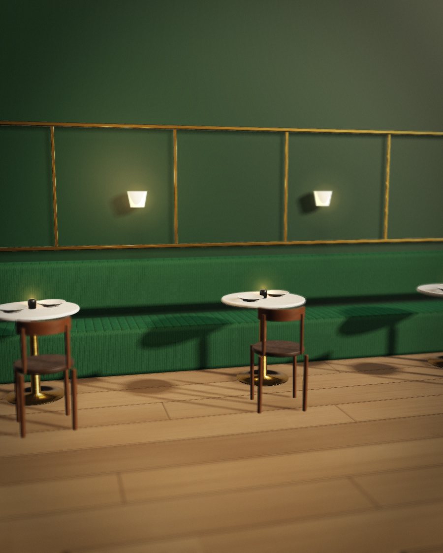 A restaurant dining room with a green velvet banquette and marble tables